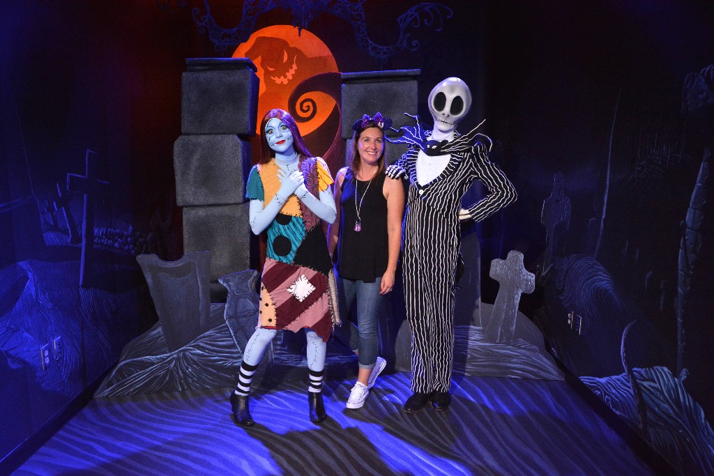 A woman poses with Jack and Sally at Mickey's Not So Scary Halloween Party
