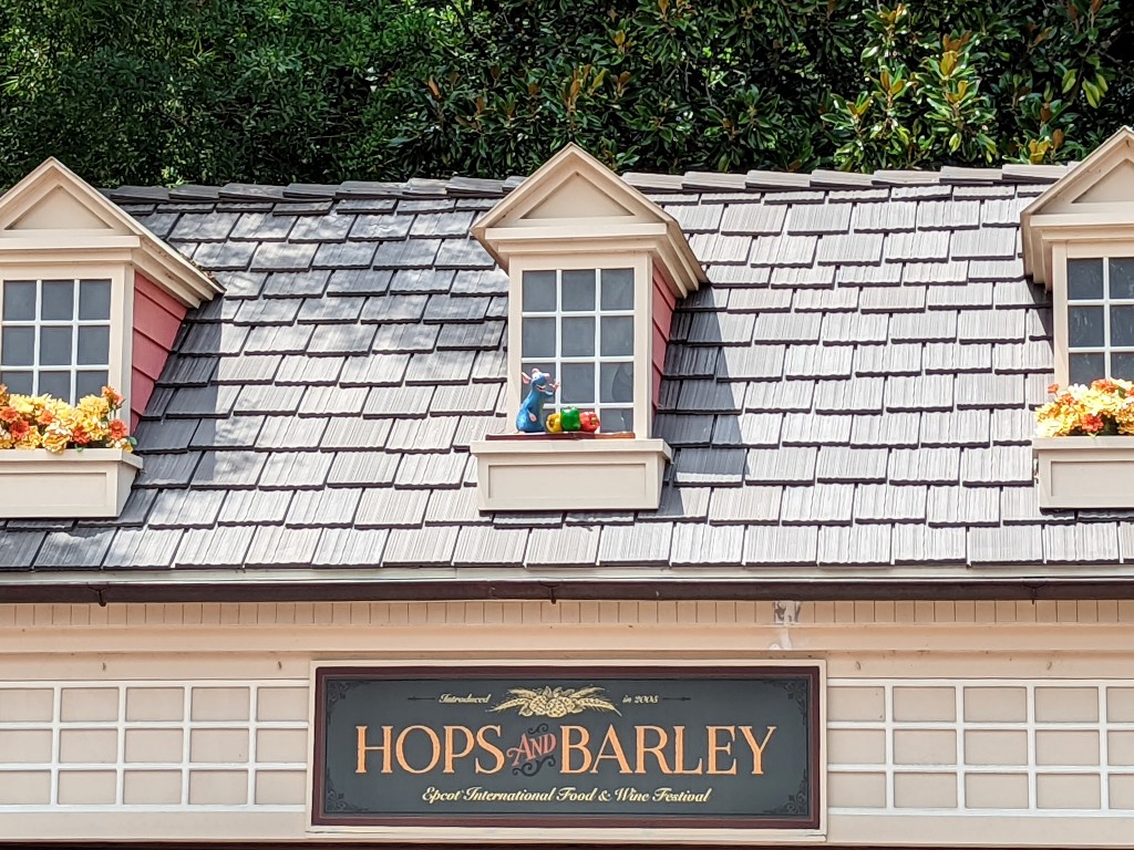 Remy peeks out of a flower box above Hops and Barley