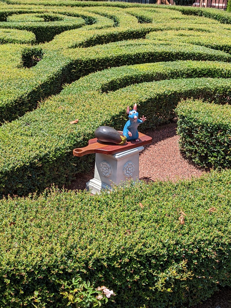 Sneaky Remy barely visible above manicured gardens in France