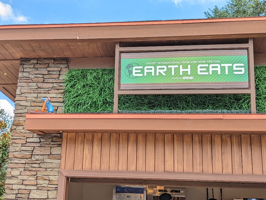 Earth Eats sign with Remy to the left side