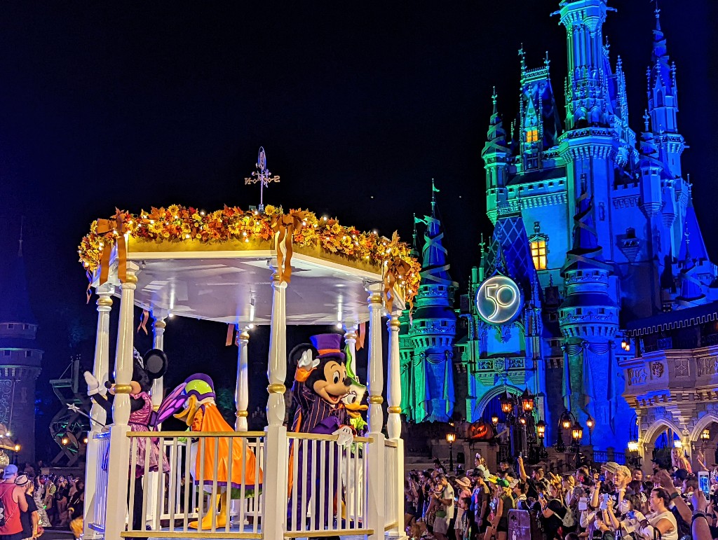 Mickey, Minnie, Daisy, and Donald dressed in halloween costumes wave to Mickey's Not So Scary Halloween Party guests during Boo To You parade