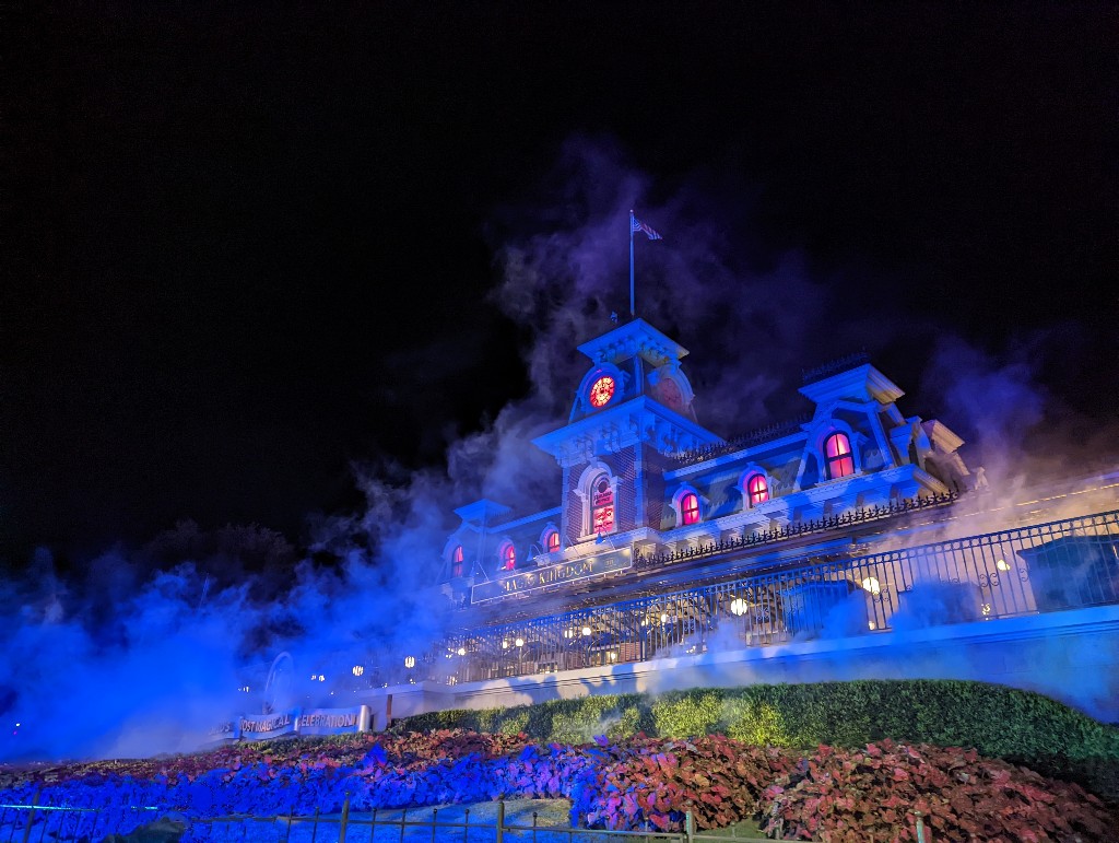 Main Street train station bathed in blue light and spooky fog at MNSSHP