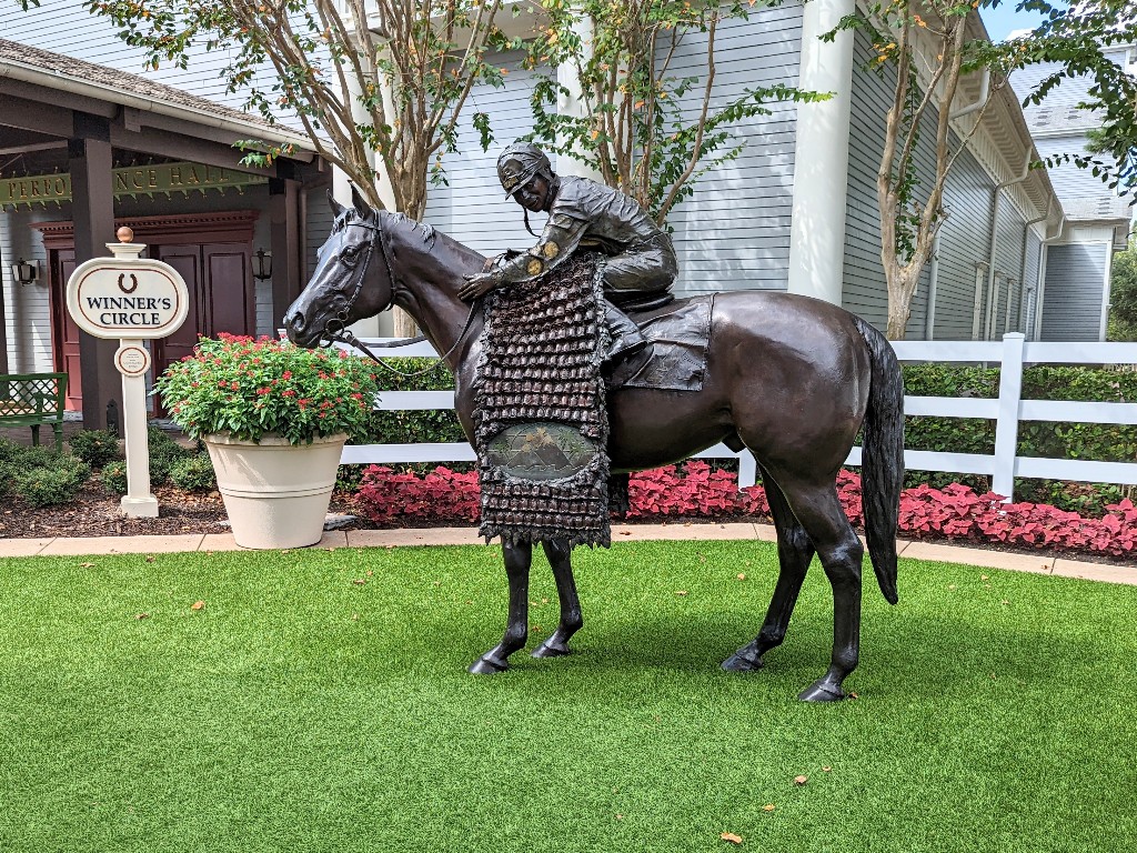 A large bronze statue of horse and jockey honor Saratoga Springs racing history