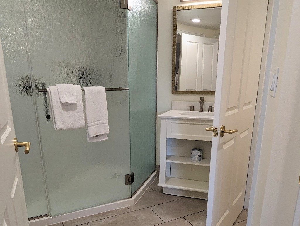 White tile and cabinets keep the bathroom fresh and clean looking