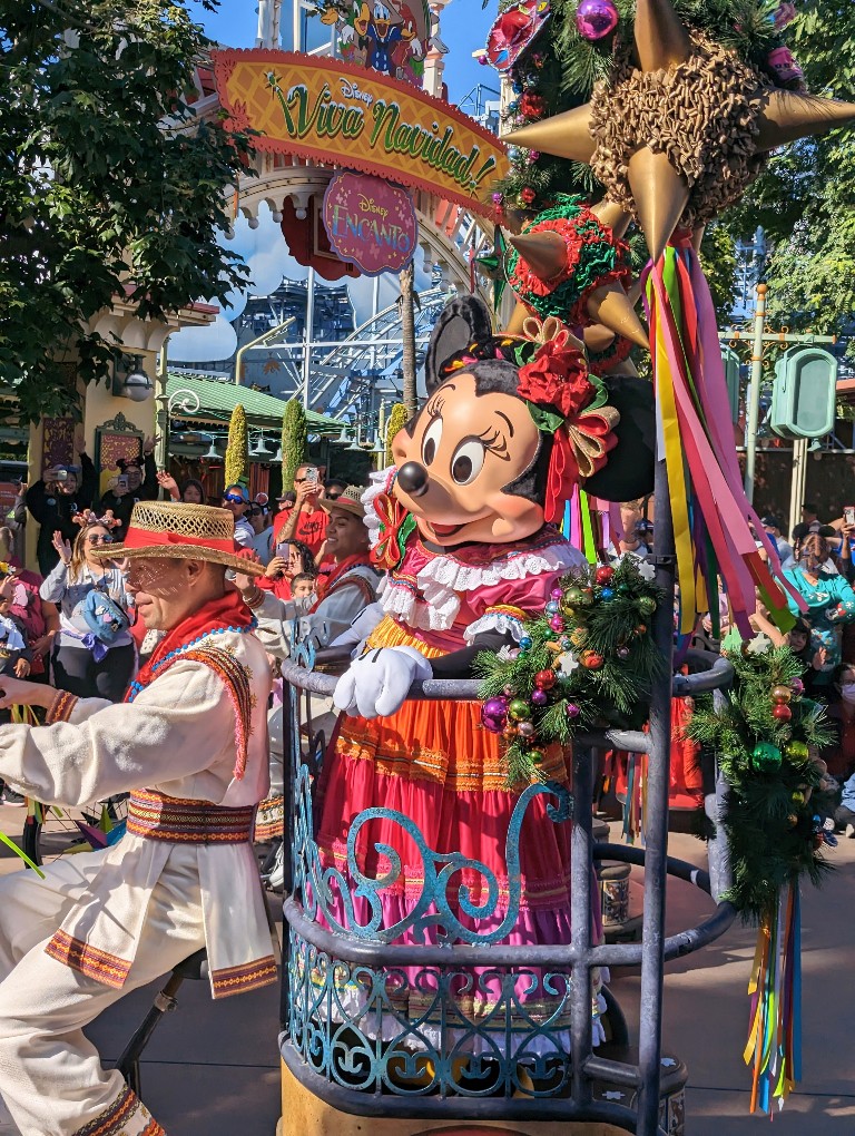 Minnie in a colorful dress participates in Disney California Adventure Viva Navidad street show