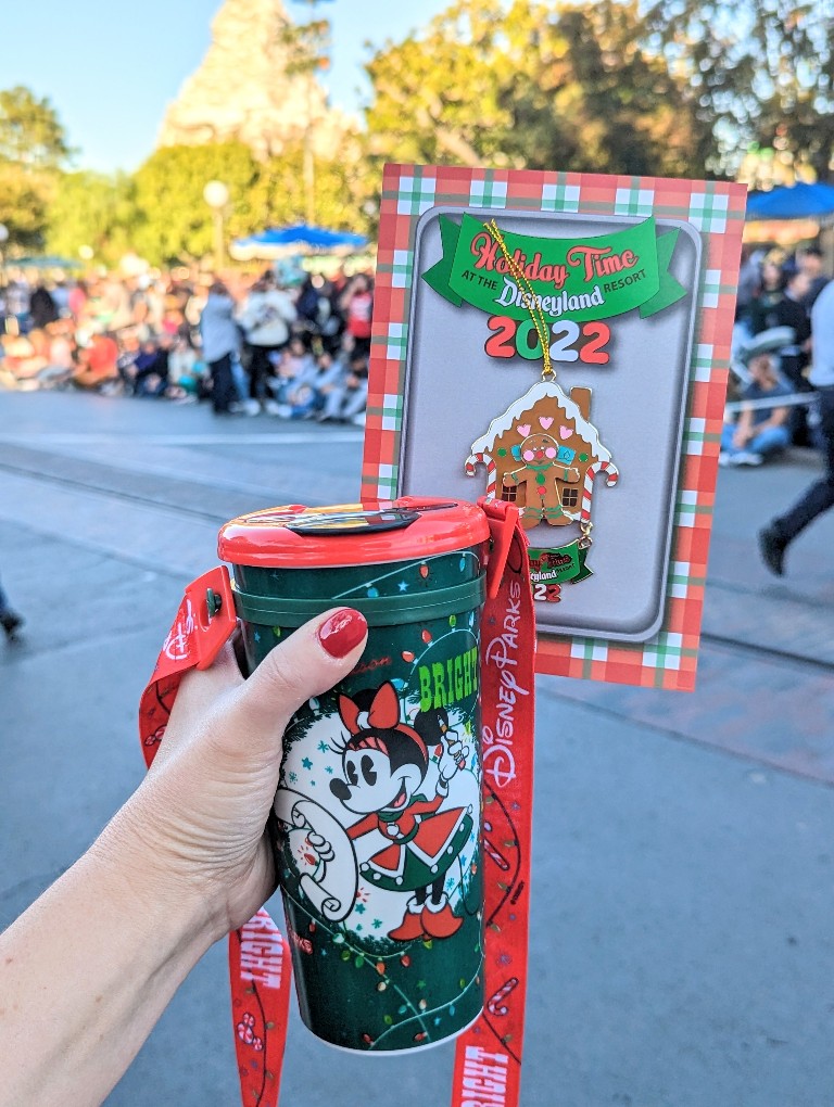 A souvenir mug filled with hot chocolate and a special edition pin ornament are wonderful keepsakes from Holiday Time at the Disneyland Resort tour