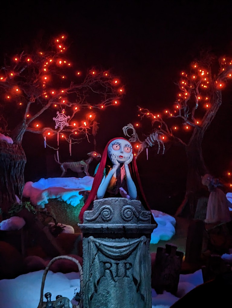 Sally stares out at the Haunted Mansion cemetery during the Haunted Mansion Holiday ride