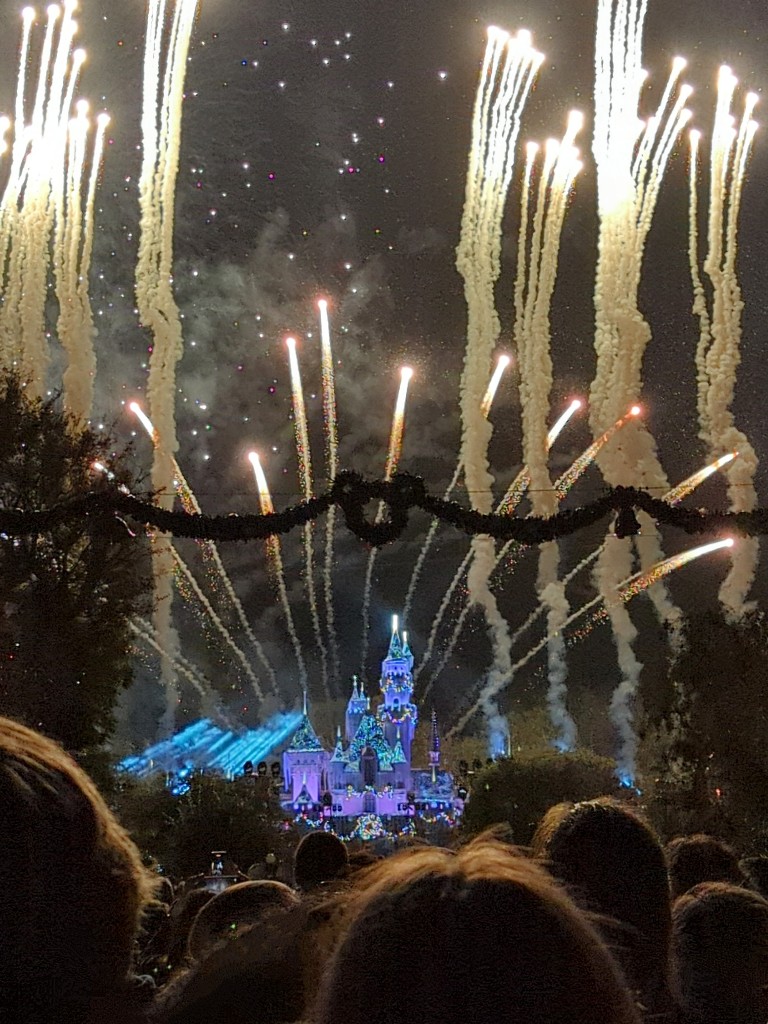 Believe in Holiday Magic Fireworks burst in the sky above a sparkling Sleeping Beauty Castle