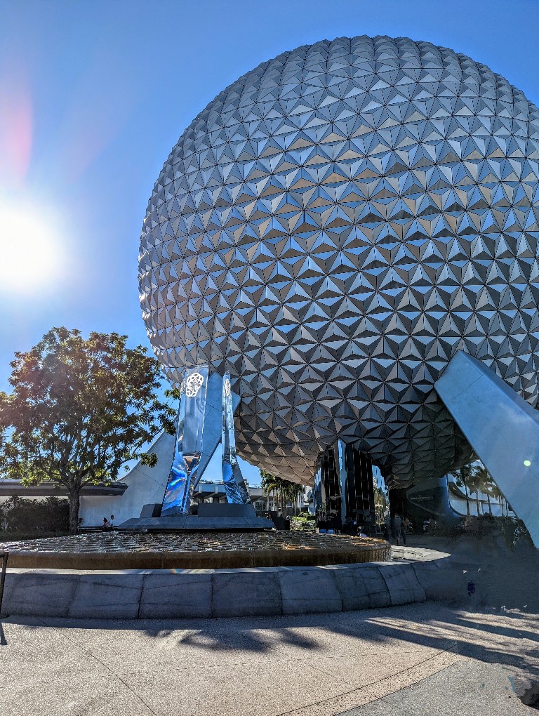 The sun sparkles over Spaceship Earth at Epcot