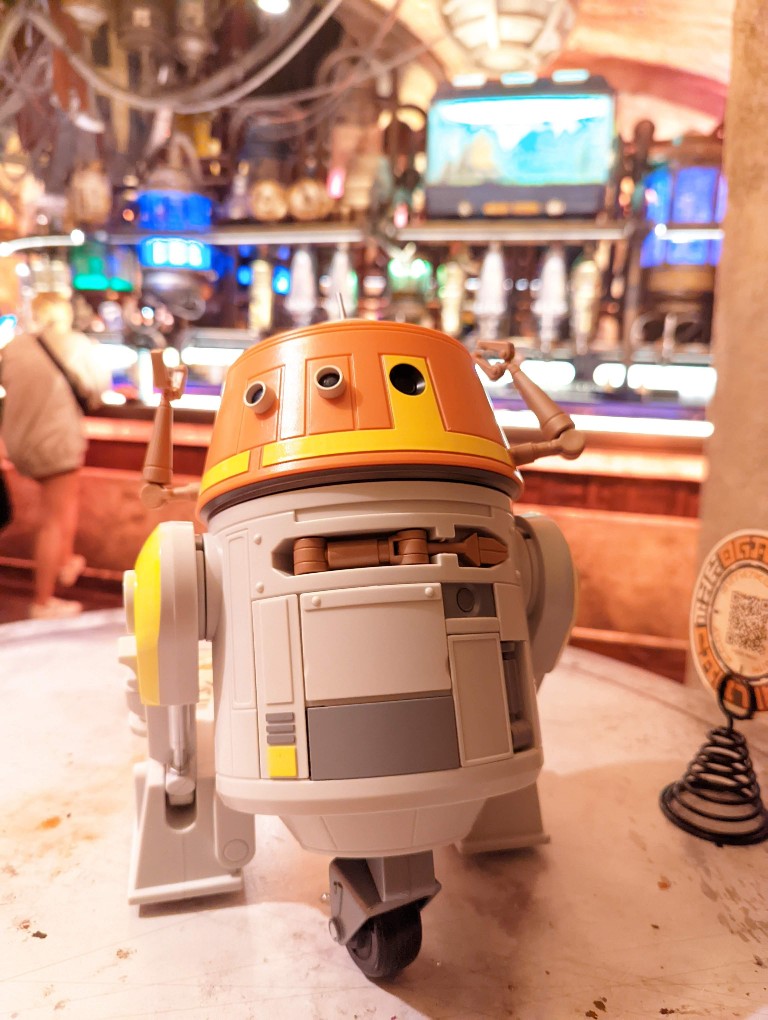 A Droid Depot C-series droid lounges at Oga's Cantina in Galaxy's Edge
