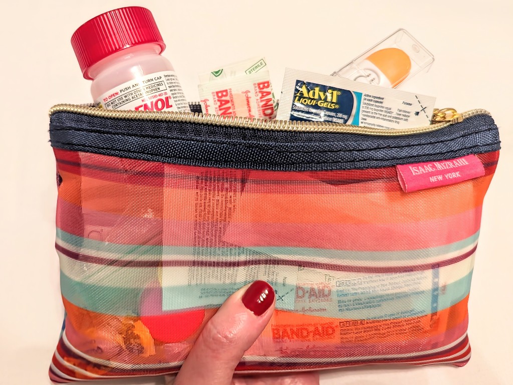 A small Disney World first aid kit with Tylenol, Advil, Band-aids, and a thermometer