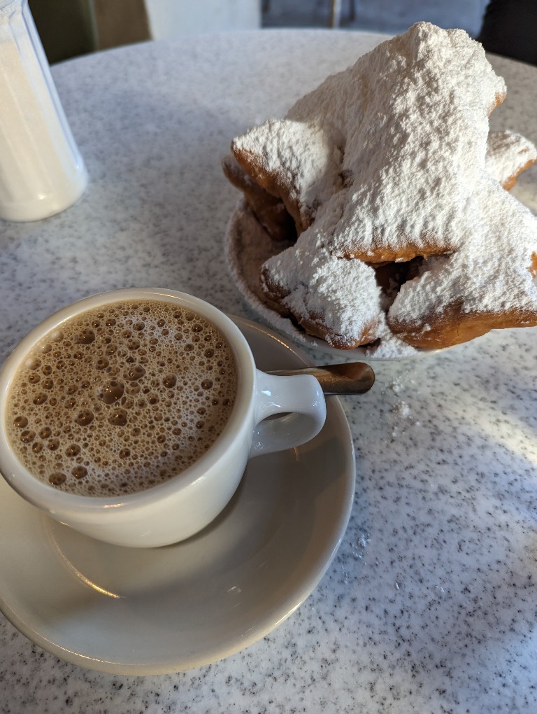 Beignets piled high with powdered sugar are a perfect treat when visiting New Orleans before or after a Disney Cruise