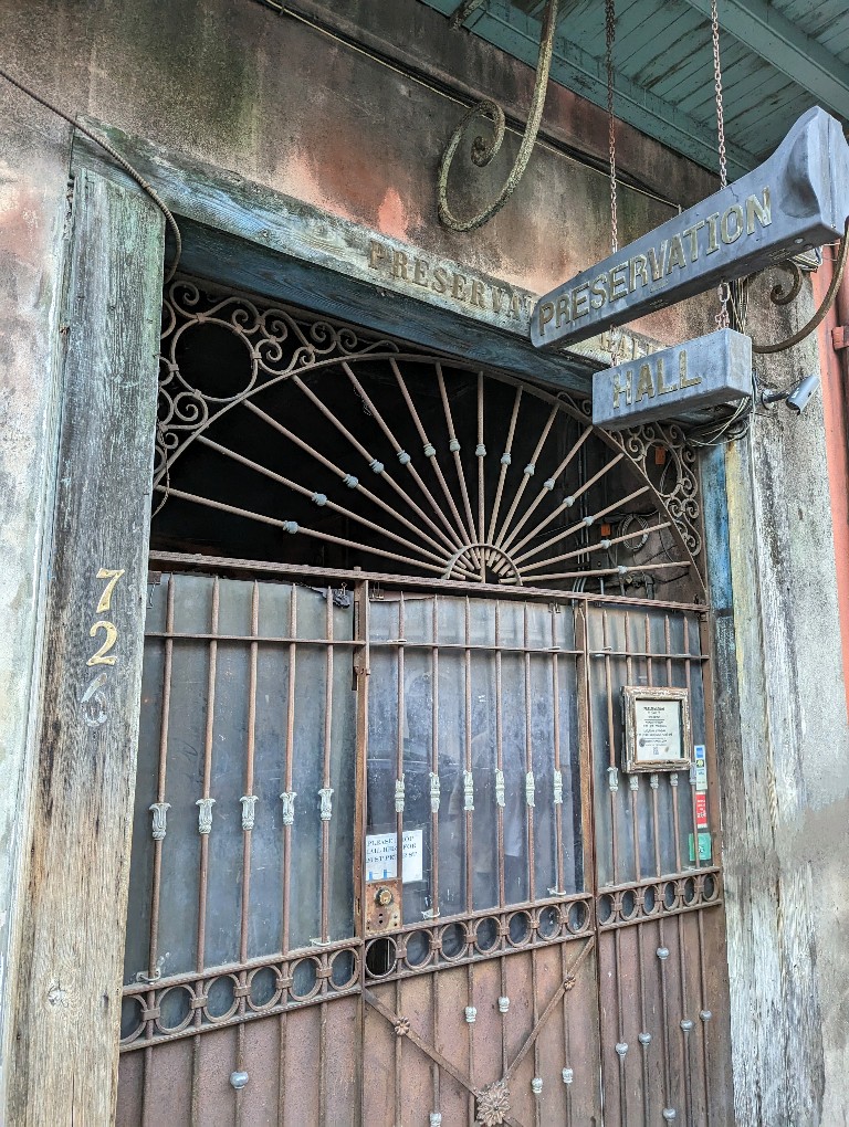 Iron gates and a weathered sign are an easily missed signal of the amazing jazz shows at Preservation Hall