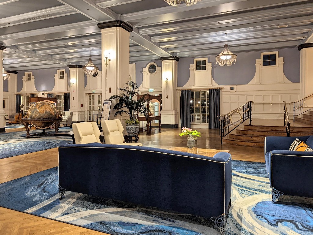 Blue hues of varying shades, white wainscoting, and a large globe welcome guests to Disney's Yacht Club Resort
