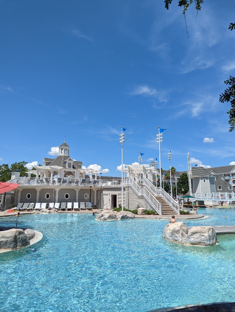 Blue skies above showcase Stormalong Bay's sand bottomed pool, lazy river, and giant water slide