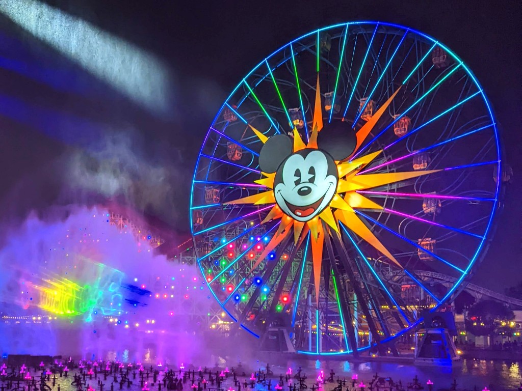 Pixar Pal-A-Round, also known as the Mickey ferris wheel, lit in a rainbow of colors during World of Color