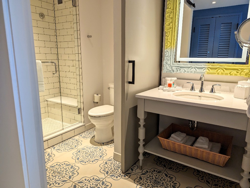 Bright white subway tile and clear glass doors make for a beautiful shower while the sliding door provides a useful split bathroom design at Sapphire Falls