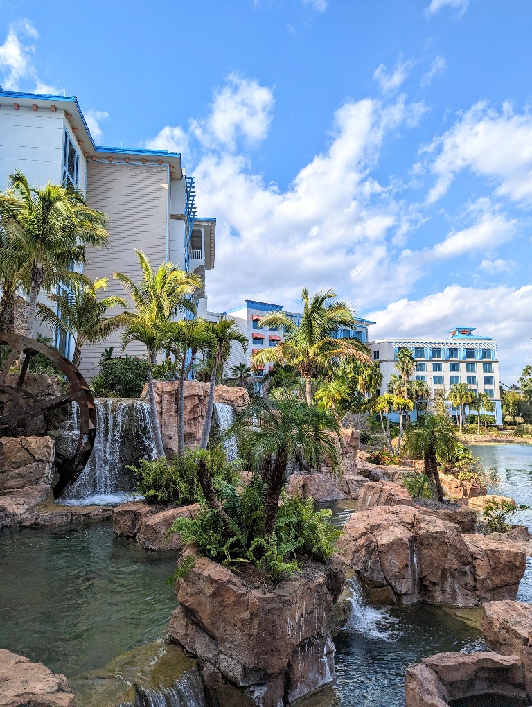 A soothing waterfall with rocks and palm trees just outside Amatista Cookhouse on the Sapphire Falls lagoon