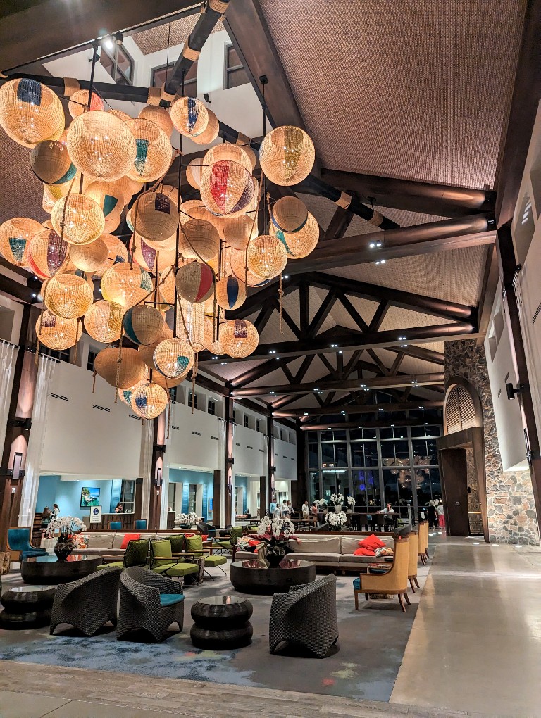 The Sapphire Falls welcoming lobby with rich neutrals and bright tropical accents greets guests entering the hotel