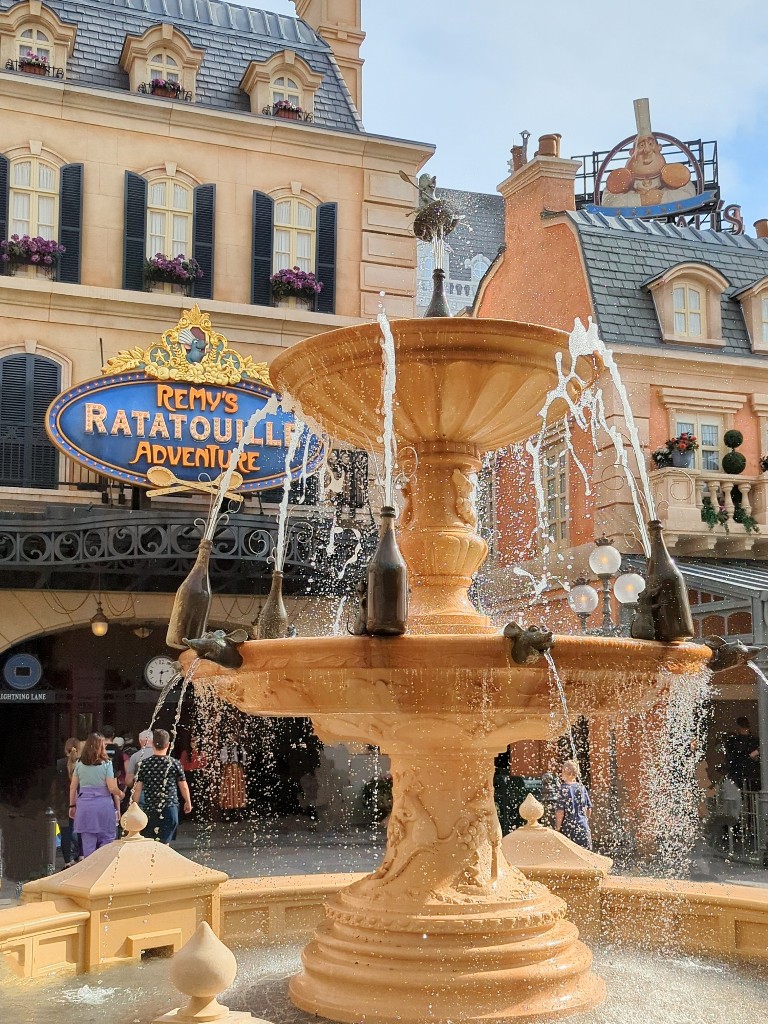 A bubbling fountain greets guests entering Remy's Ratatouille lightning lane entrance when using Disney World Genie Plus