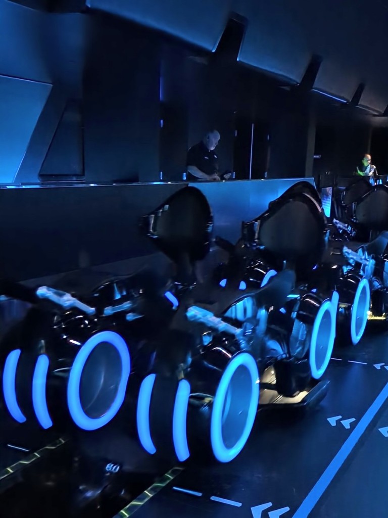 A close up view of the Lightcycle ride vehicles trimmed in blue lights perfectly matched to those from Tron and Tron:Legacy