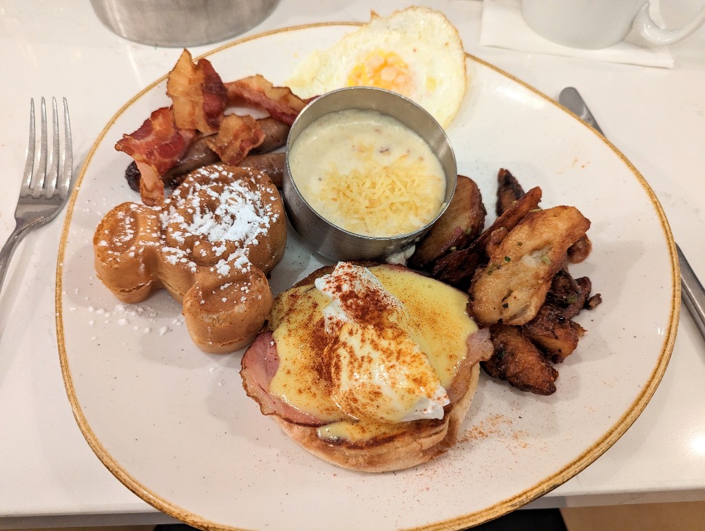 Steakhouse 71 breakfast with delicious potatoes, eggs, Mickey waffle, and cheesy grits