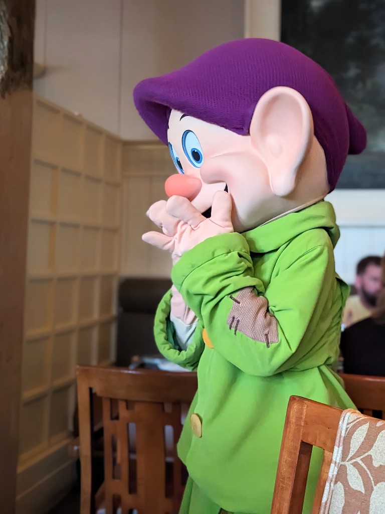 Dopey covers his mouth in excitement as he approached our table at Story Book Dining at Artist Point