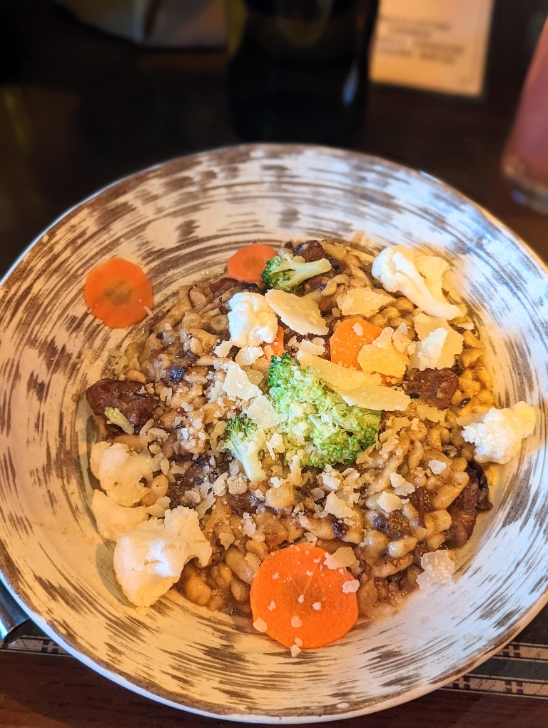 Colorful veggies and shaved aged cheese adorn the beef stroganoff entree.