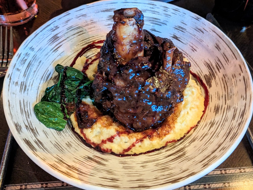 Braised lamb shank on a bed of polenta is an incredible entree at Artist Point