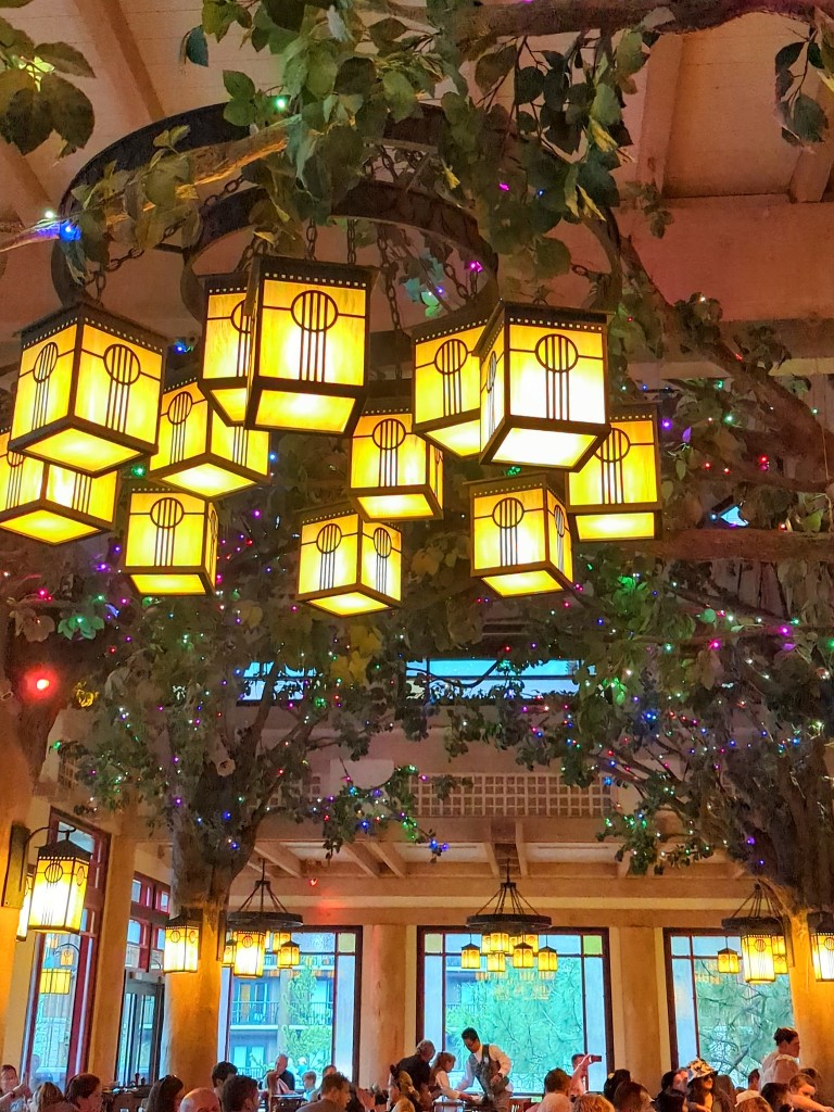 Lanterns and colorful fairy lights enhance the branches of the faux trees which turn Artist Point into the Enchanted forest