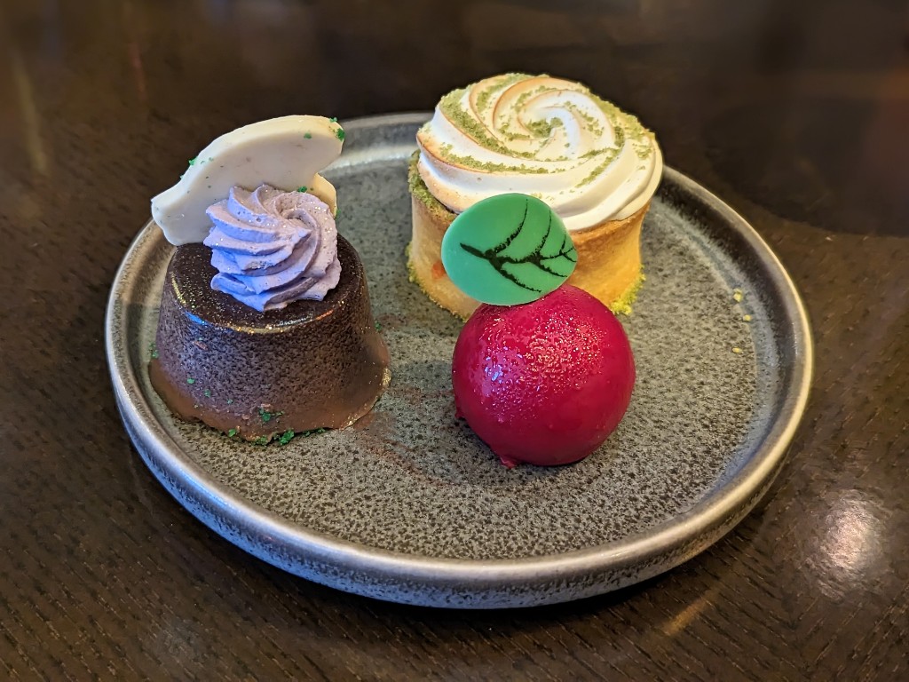 A trio of desserts on a plate at Story Book Dining at Artist Point with Snow White