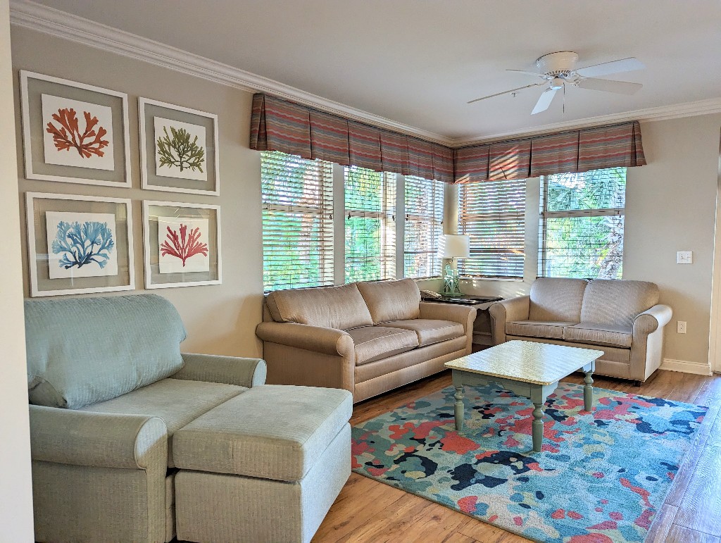 Framed, colorful coral prints and comfortable furniture make a welcoming living room in an Old Key West 1 bedroom villa