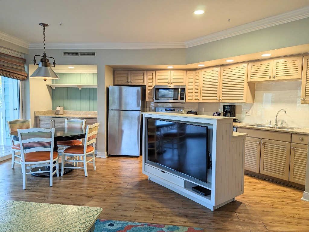 A full kitchen with refrigerator, range and oven, dishwasher, microwave and more plus a dining table for four makes Old Key West 1 bedroom villas feel like home