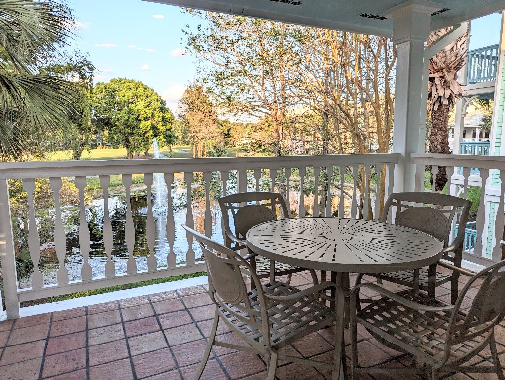 A gorgeous golf course view with a small pond and greenery plus a large patio set makes a perfect place to relax in our Old Key West 1 bedroom villa