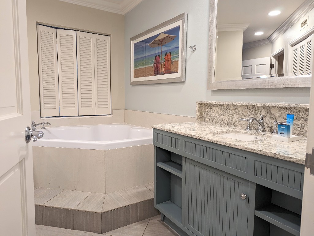 The semi-private bathroom area in a Old Key West 1 bedroom villa with a soaker tub and vanity.