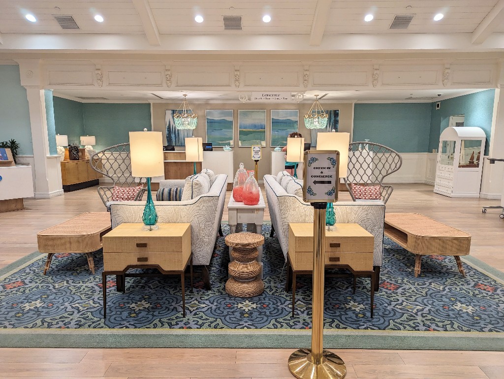 Light color wood, neutral furniture, and beachy blue, green, and coral accents welcome guests to Old Key West's lobby