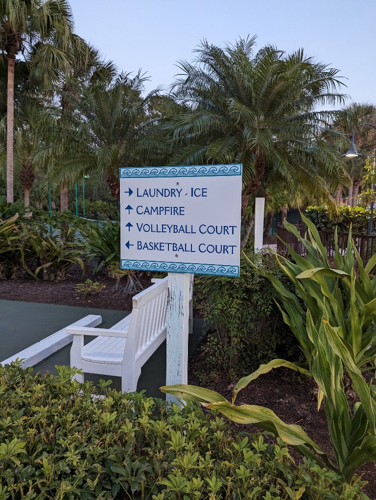 A sign directs guests at Hospitality House to the volleyball and basketball courts