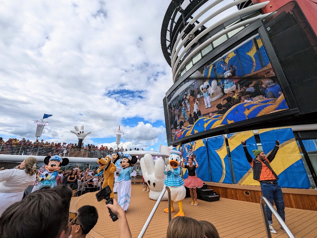 Mickey, Minnie, Donald, Pluto. and Goofy kick off a Disney Cruise by performing during the Sail A Wave Deck Party