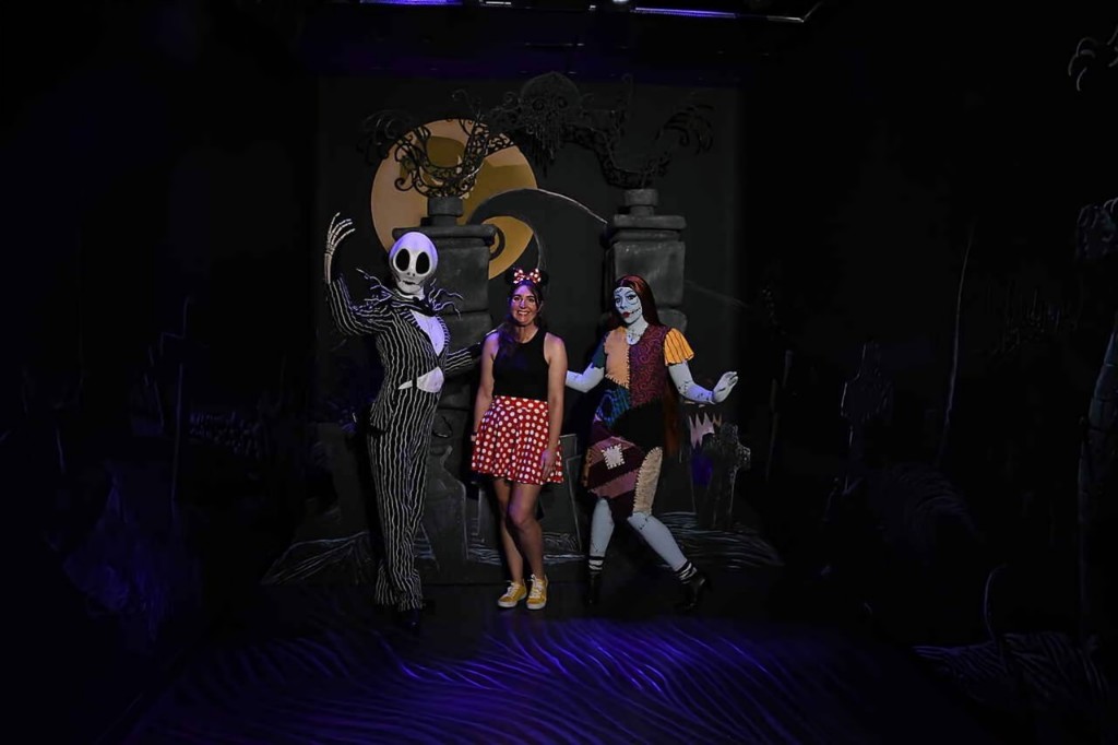 A woman poses with Jack and Sally during Mickey's Not So Scary Halloween Party