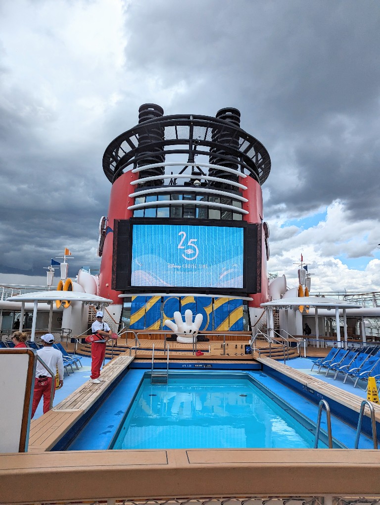 Gray skies on embarkation day and an empty pool make for a great time to swim and use the water slide on a Disney Alaska cruise