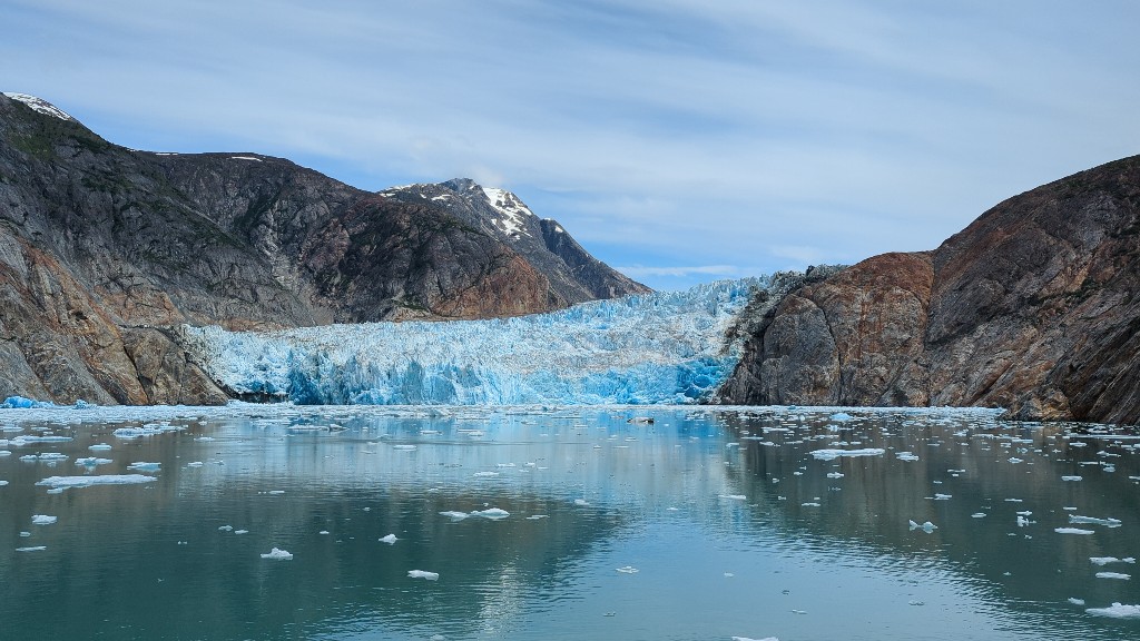 Shockingly blue ice of a glacier with small specks of black seal cubs resting in this safe area.