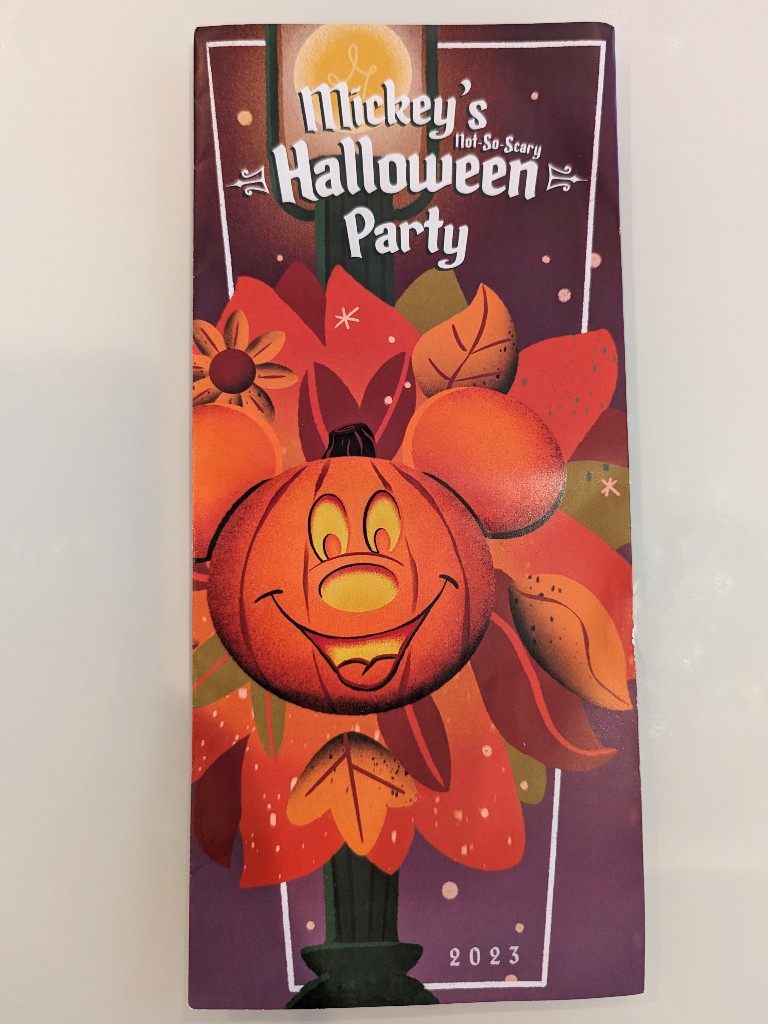 A 2023 Mickey's Not So Scary Halloween Party map cover with Mickey pumpkin wreath design