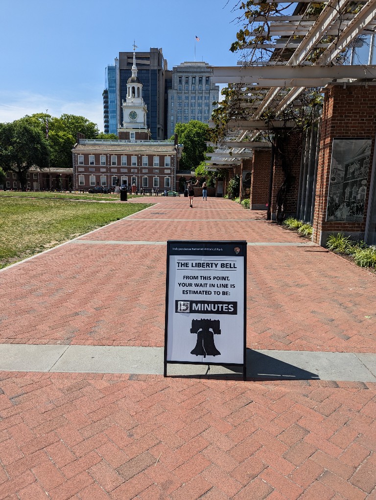 A sign says the security wait for Liberty Bell will take 15 minutes from this point