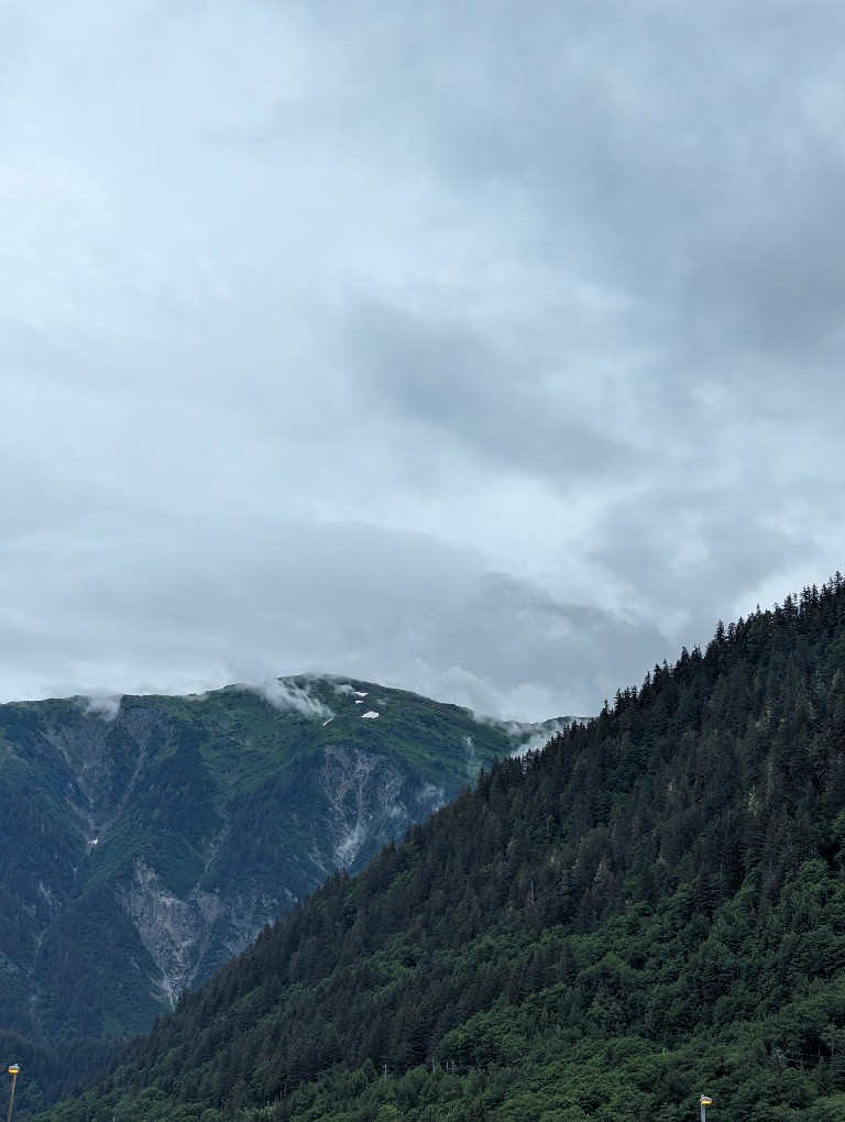 Clouds brush the top of mountains in Juneau
