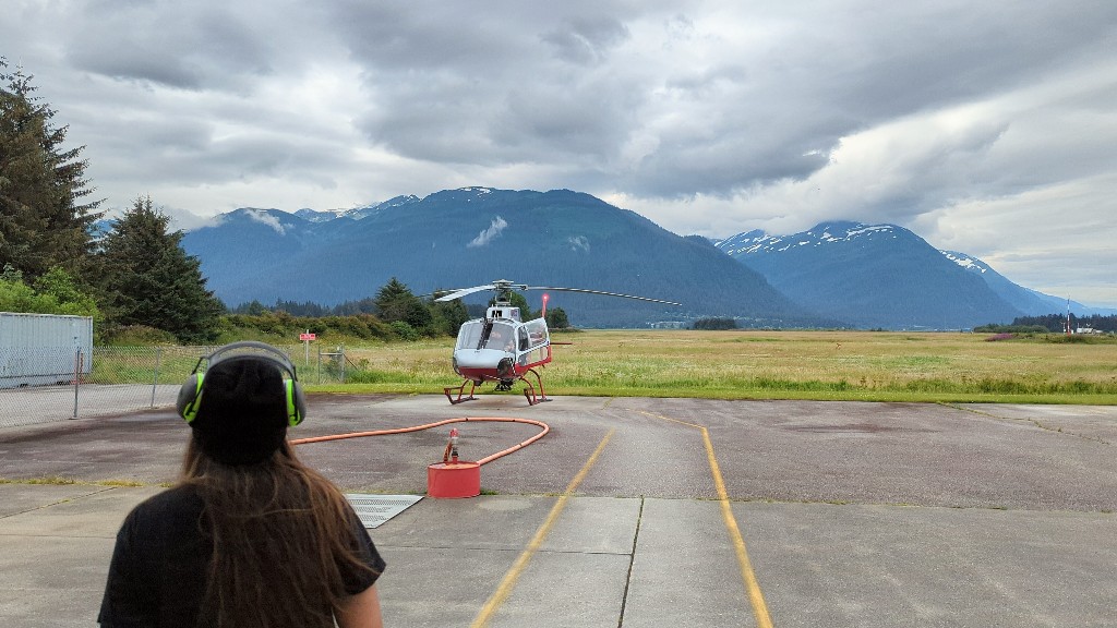 A helicopter on a Juneau airfield with mountains in the background