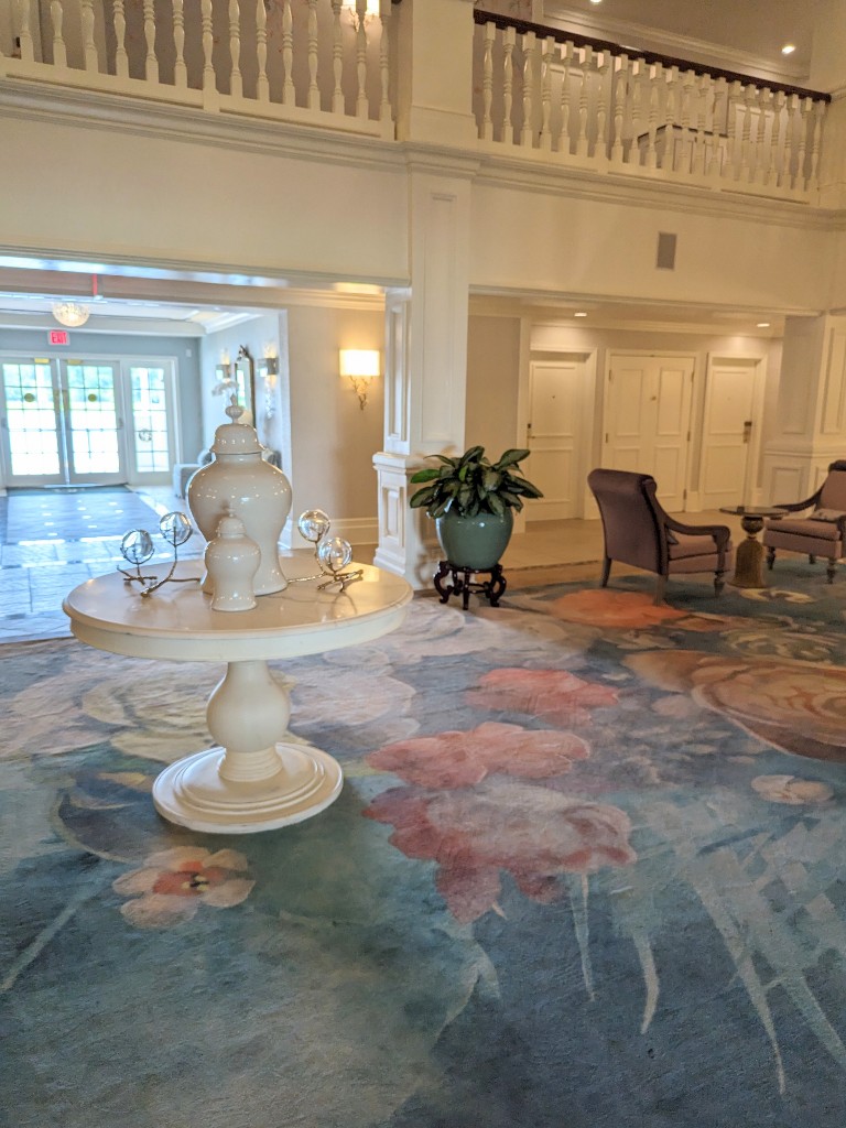 Grand Floridian Resort Outer Building Lobby remodel has gorgeous floral carpets, traditional furniture, and Mary Poppins inspired art