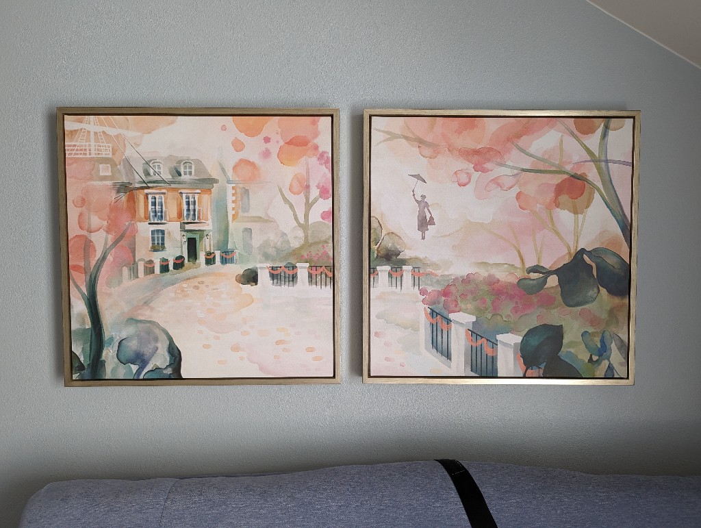 A two piece framed art set depicts Mary Poppins floating down towards the Banks family home