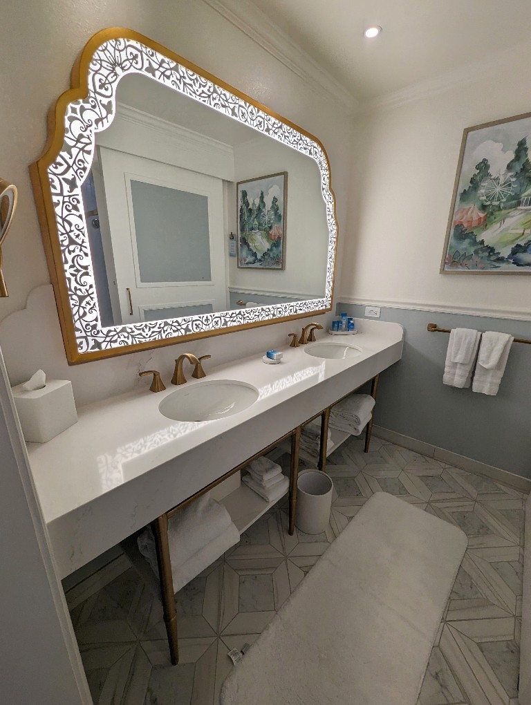 Gold framed filigree mirror hangs above a double sink in Disney's Grand Floridian Resort newly remodeled rooms