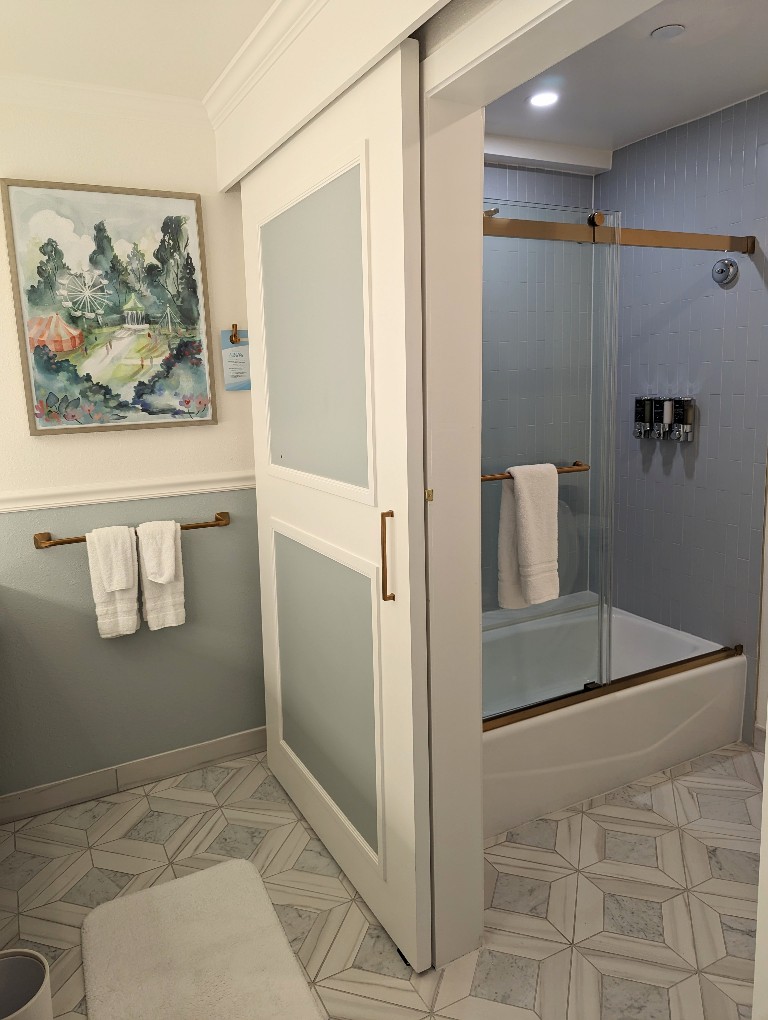 A wooden sliding door separates the Grand Floridian resort bathroom into two different areas for maximum privacy