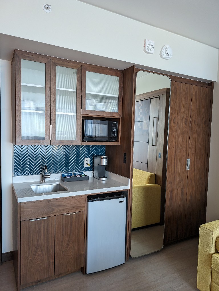 Disneyland Hotel studio villa kitchenette with mini fridge, microwave, sink, and fully supplied dishes
